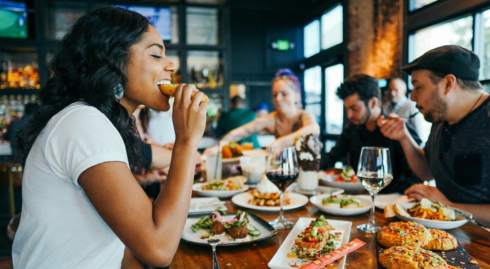 Bustling community with plenty of dining choices a group of people eating at a restaurant