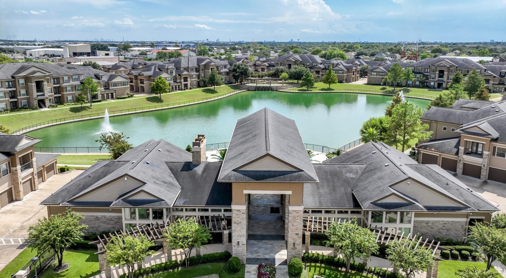 Find your perfect fit at The Falls at Copper Lake a building with a pond in the front