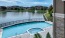 a pool with a body of water and a fountain near it