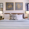 a bedroom with bed and lamps