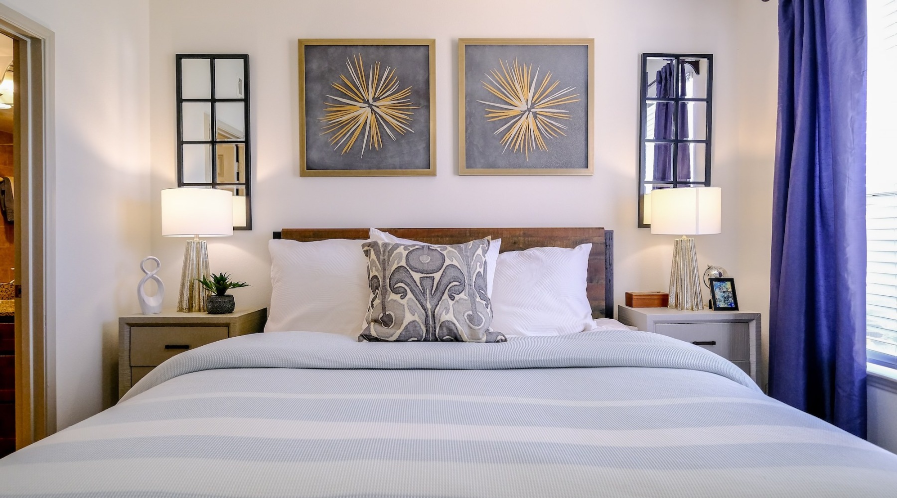 a bedroom with bed and lamps