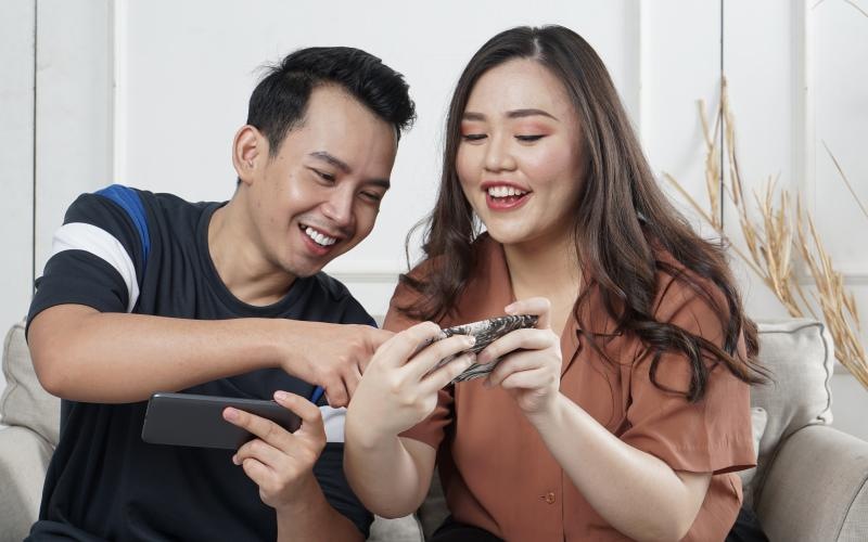 a man and woman looking at their phones