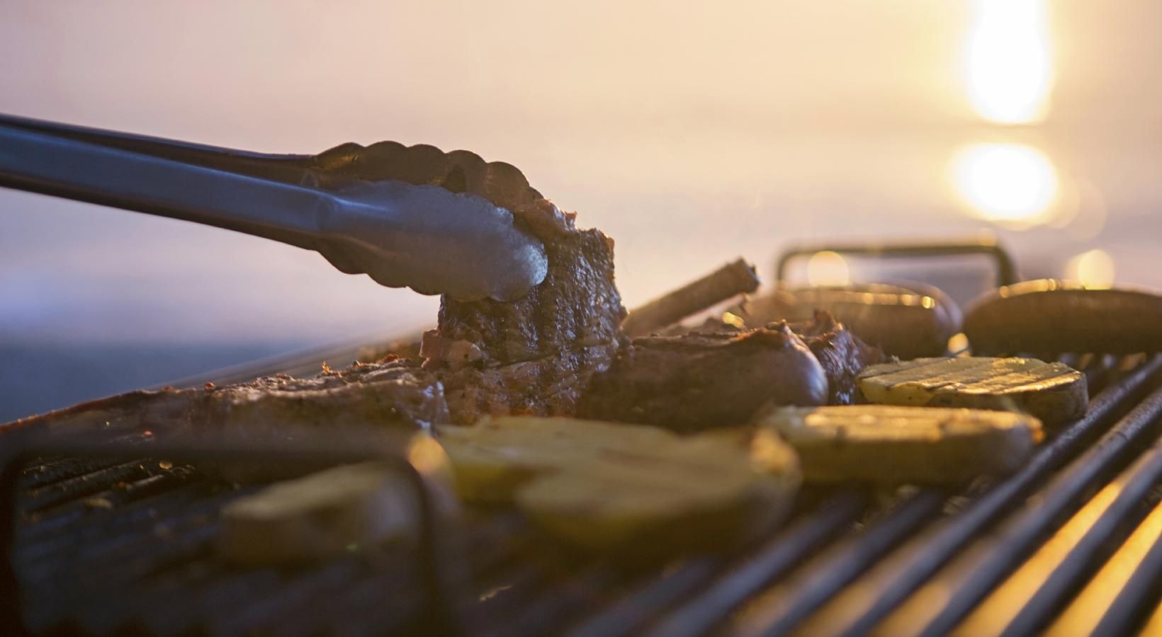 Settle into comfort at The Falls at Copper Lake a person grilling burgers