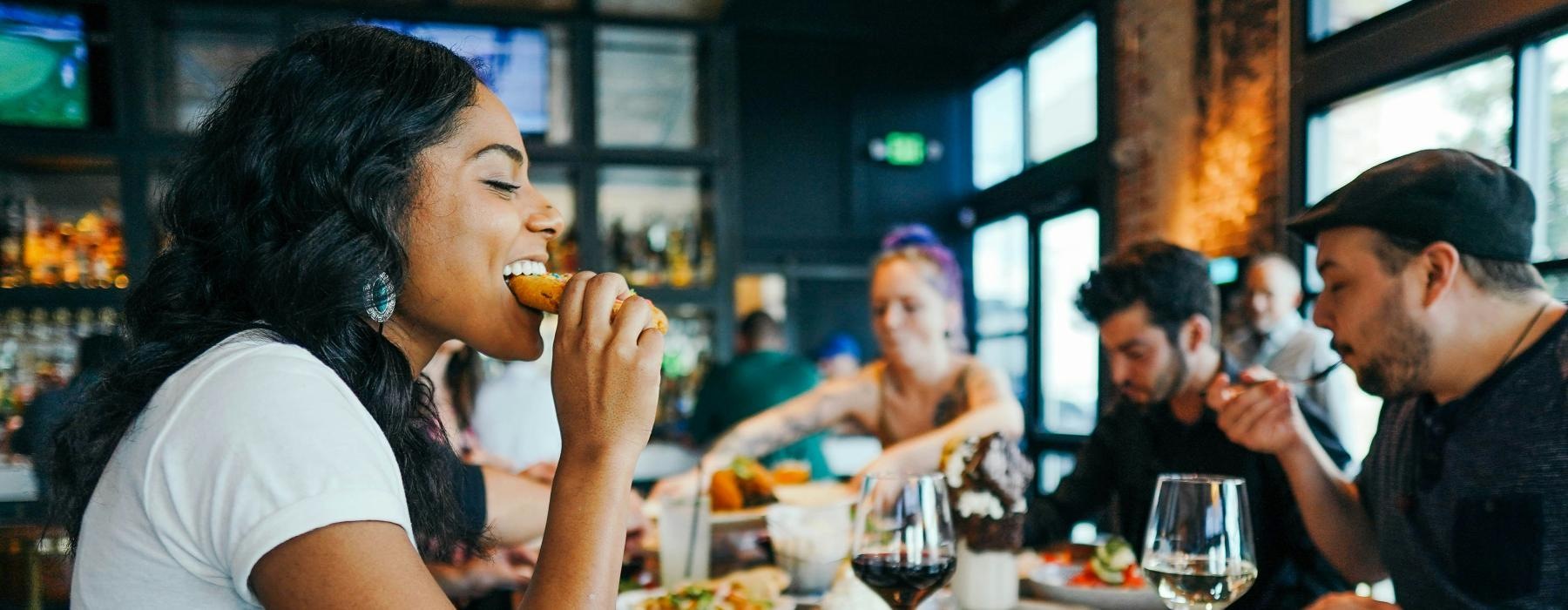 a group of people eating at a restaurant