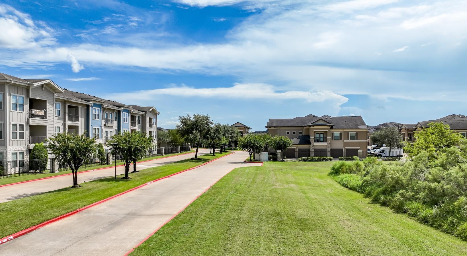 Settle into comfort at The Falls at Copper Lake a building with a lawn and trees