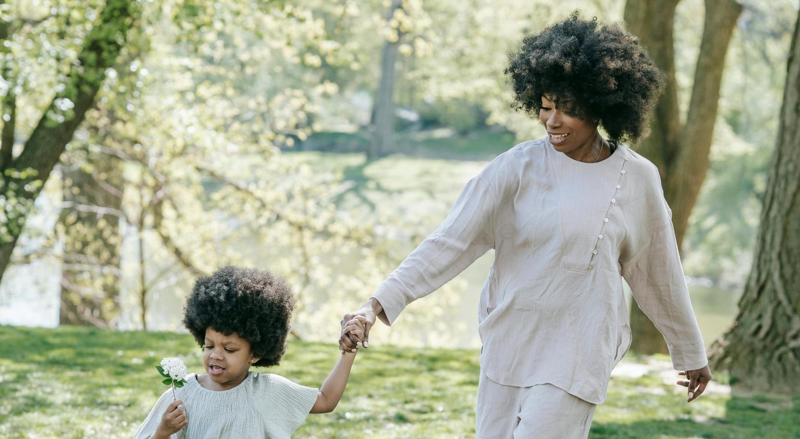 Settle into comfort at The Falls at Copper Lake a person and a child walking on grass